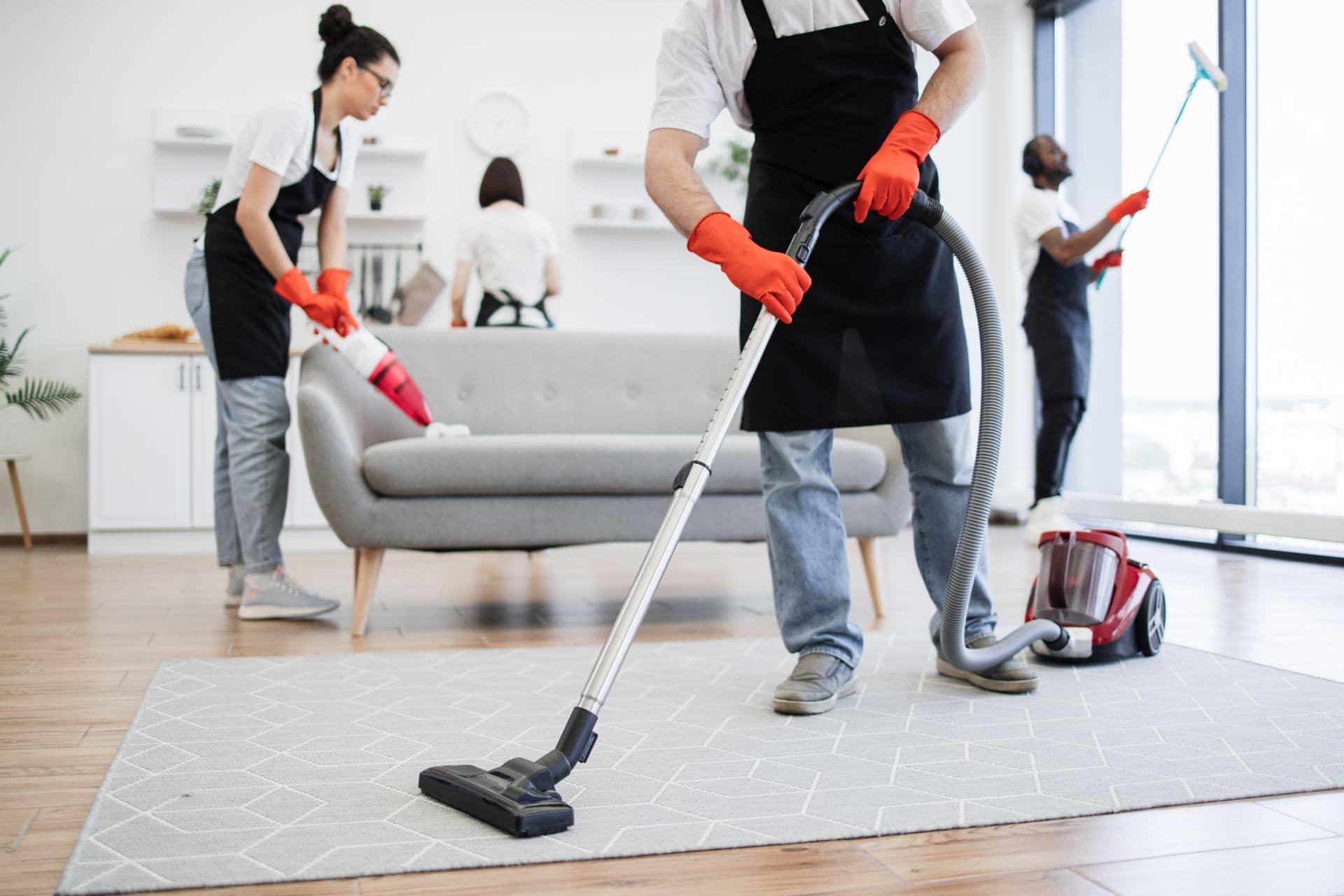 Professional cleaning team deep cleaning a Dubai apartment living room
