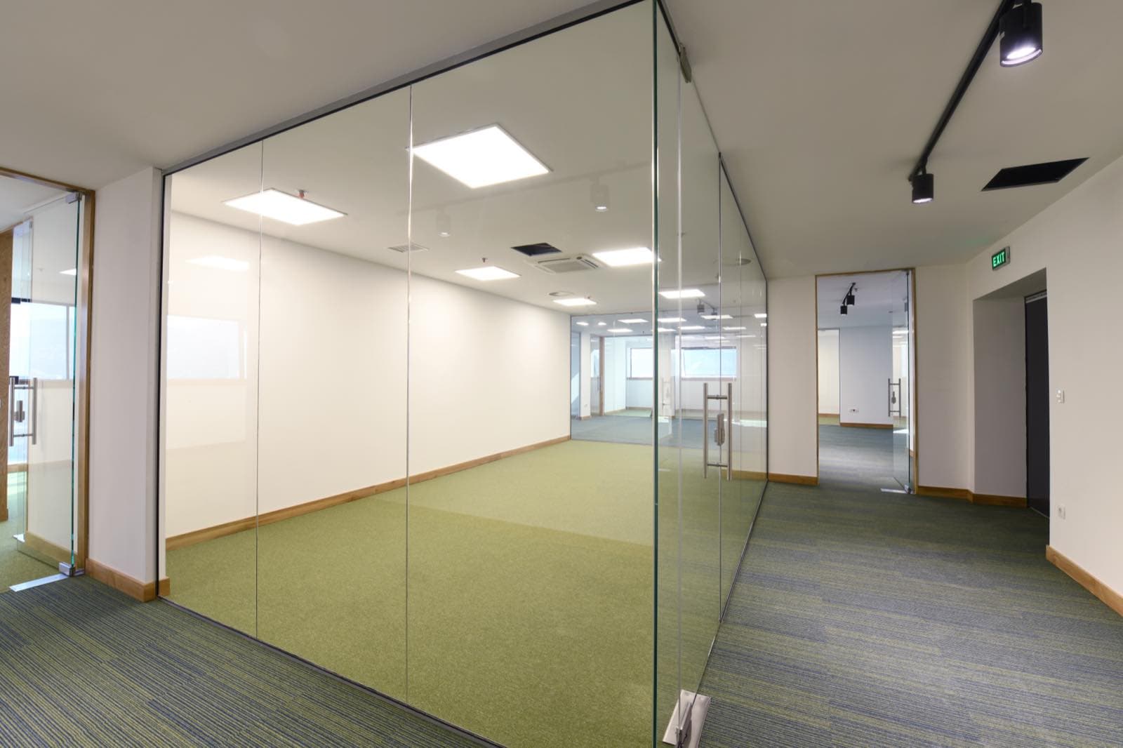 Pre-Handover Office Repaint in Dubai: Empty new office with glass partitions ready for handover