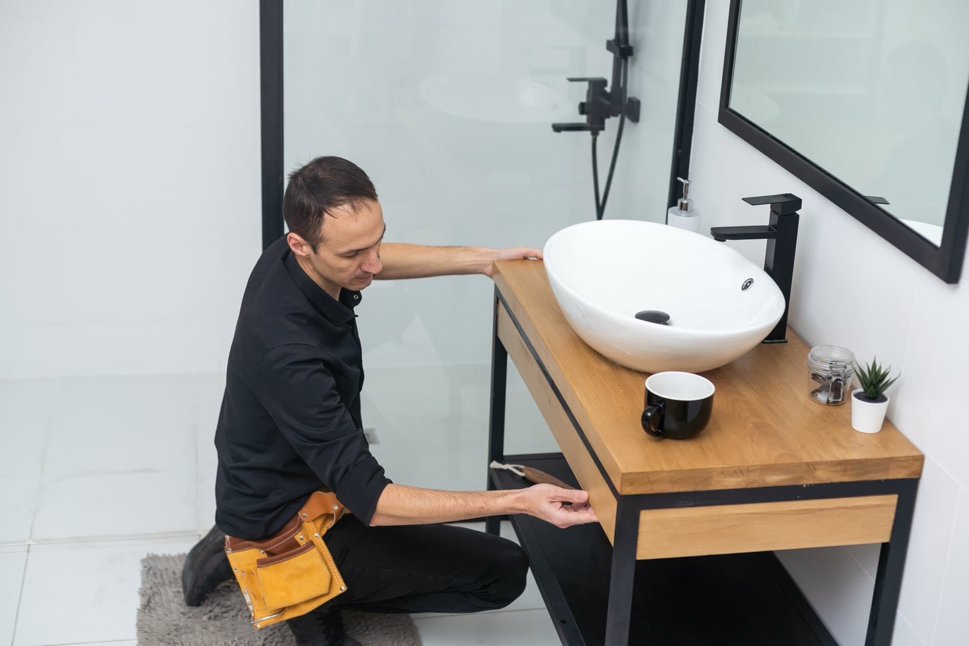 Bathroom Fittings Installation in Dubai: Plumber fitting a new basin and vanity unit in a Dubai bathroom