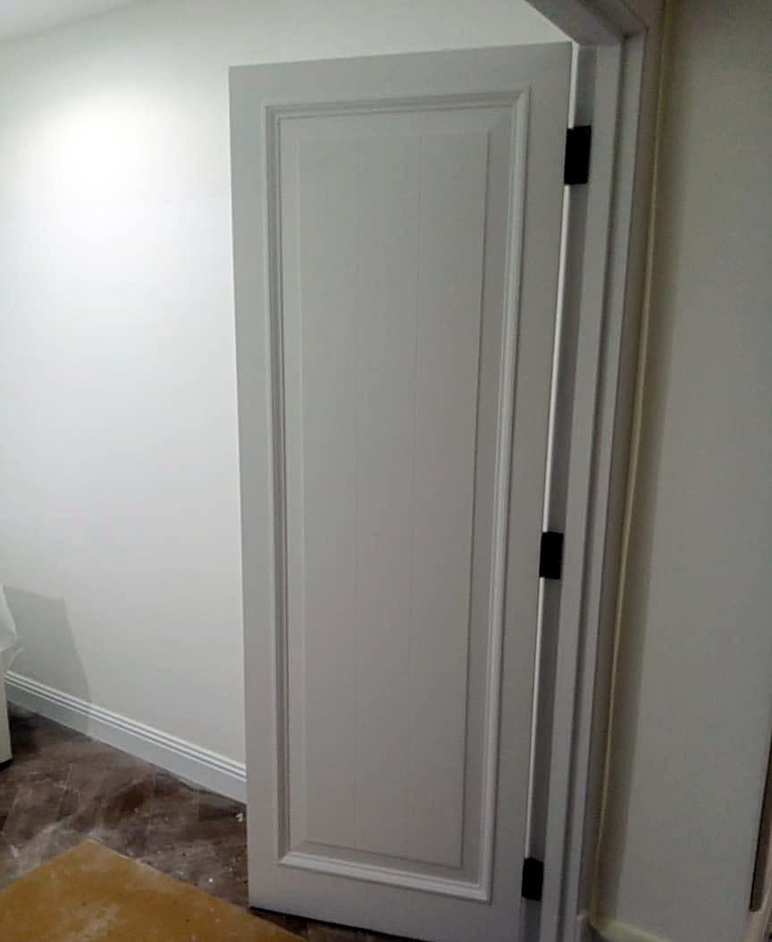 Interior Door Painting in Dubai: White panelled door freshly repainted in an apartment