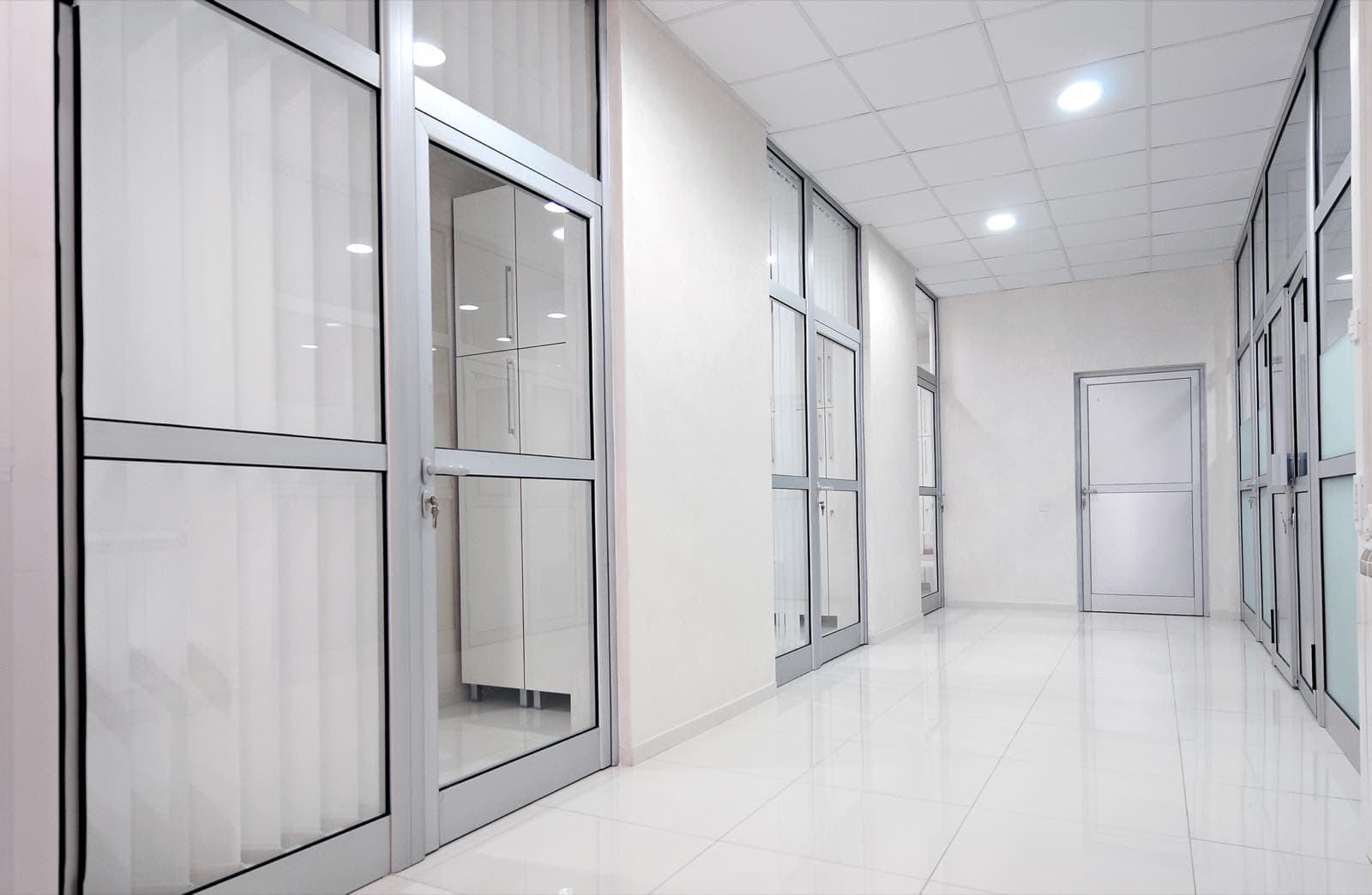 Private Office and Corridor Painting in Dubai: Empty office corridor with white walls and glass doors