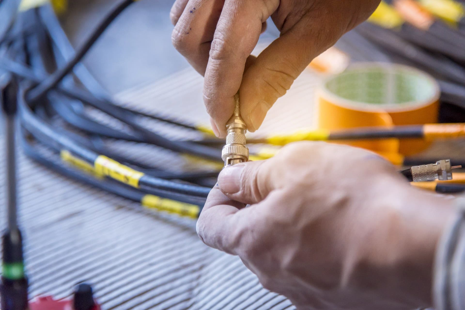 CCTV Cabling and Power in Dubai: Technician fitting a connector to a CCTV camera cable