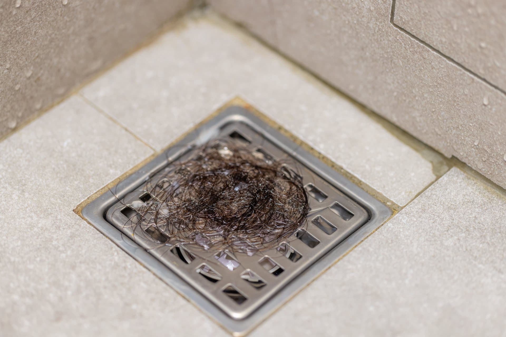 Floor Drain Cleaning in Dubai: Floor drain grate blocked with hair