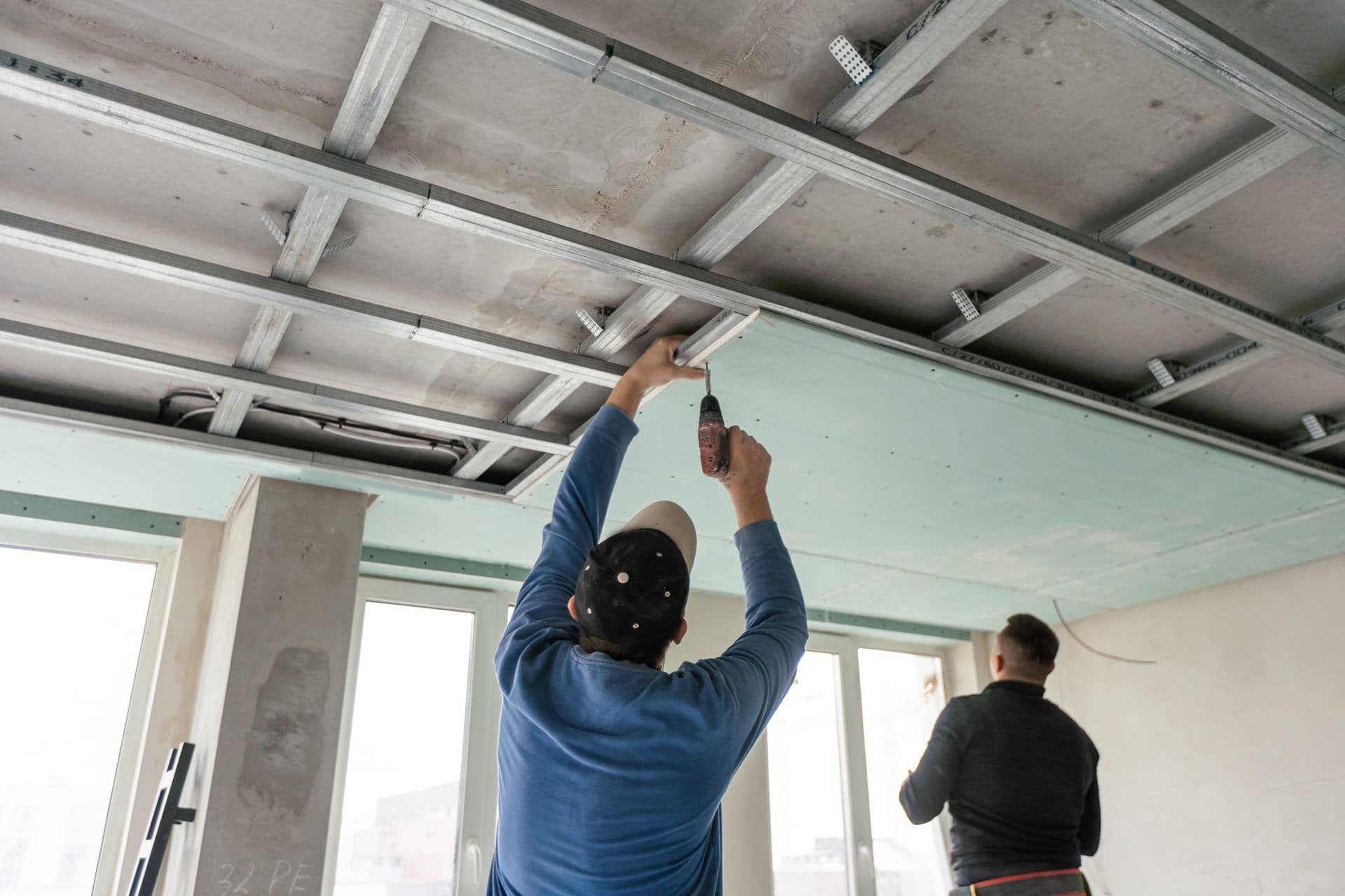 Workers fitting a gypsum false ceiling in a Dubai apartment