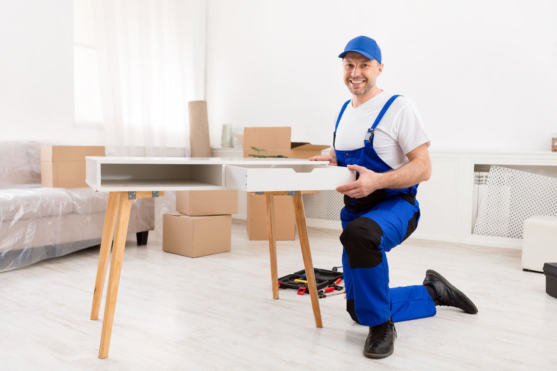 Desk and Office Furniture Assembly in Dubai: Handyman assembling and installing a wooden desk